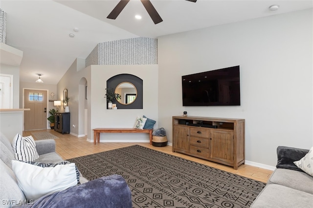 living room featuring lofted ceiling, ceiling fan, and light hardwood / wood-style floors