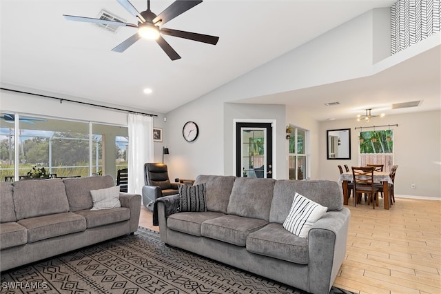 living room with a wealth of natural light, ceiling fan, high vaulted ceiling, and light hardwood / wood-style floors