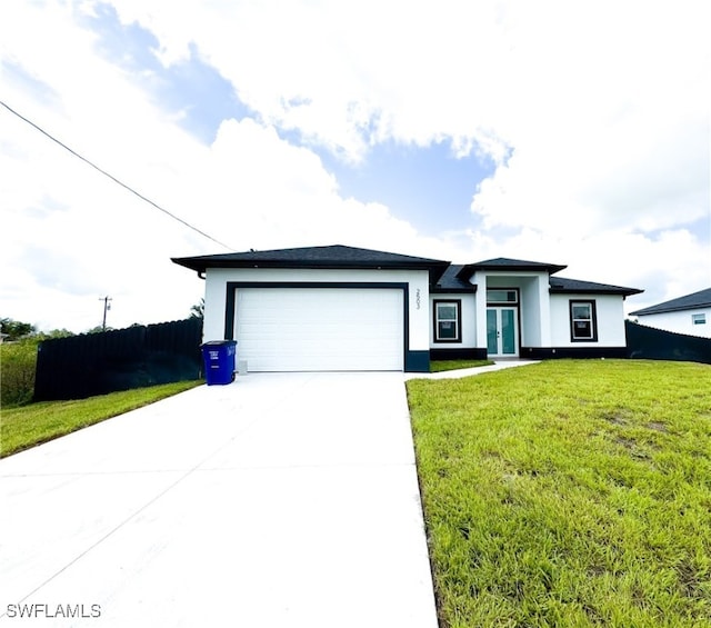 view of front of home with a garage and a front yard