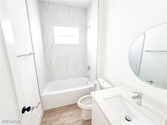 full bathroom featuring vanity, toilet, tiled shower / bath combo, and hardwood / wood-style flooring