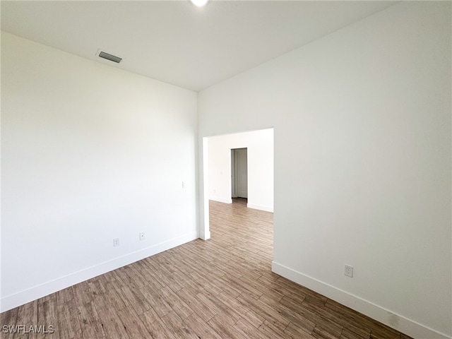 empty room with hardwood / wood-style floors