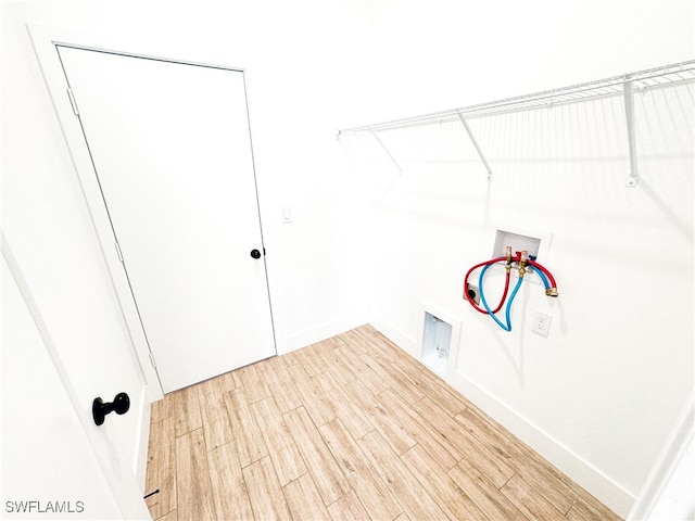 clothes washing area featuring hookup for a washing machine and wood-type flooring