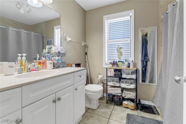 bathroom featuring vanity, walk in shower, tile patterned flooring, ceiling fan, and toilet