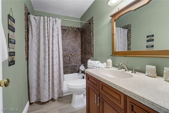 full bathroom with shower / bath combo, hardwood / wood-style floors, vanity, and toilet