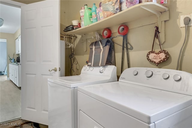 washroom with washing machine and clothes dryer