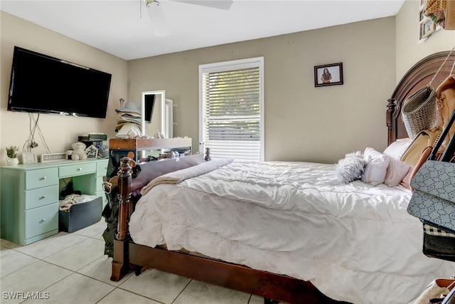 tiled bedroom featuring ceiling fan