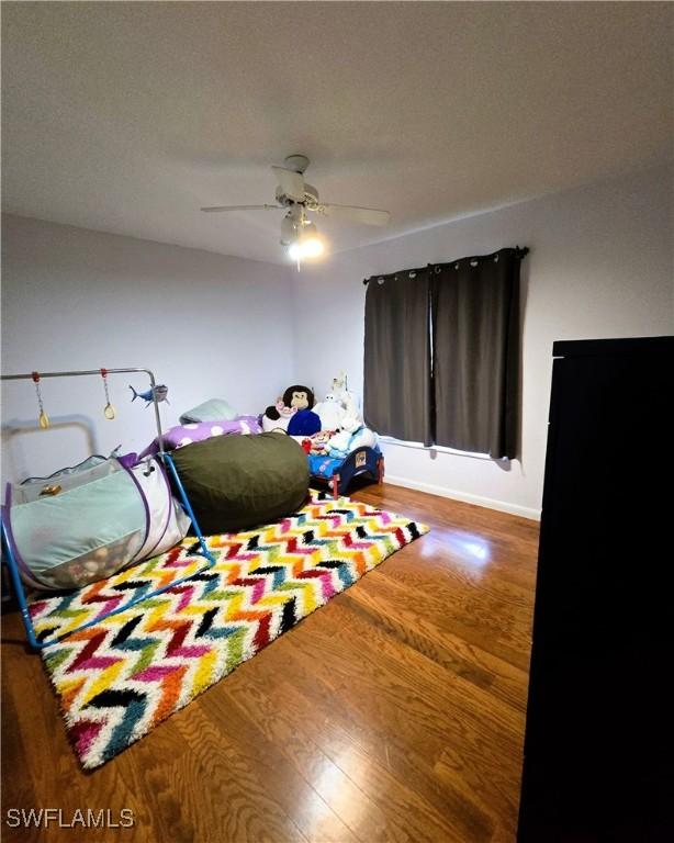 bedroom with hardwood / wood-style flooring and ceiling fan