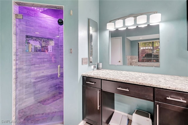 bathroom featuring vanity and a shower with shower door