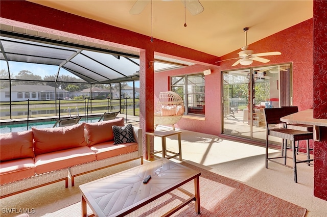 sunroom / solarium with ceiling fan and lofted ceiling