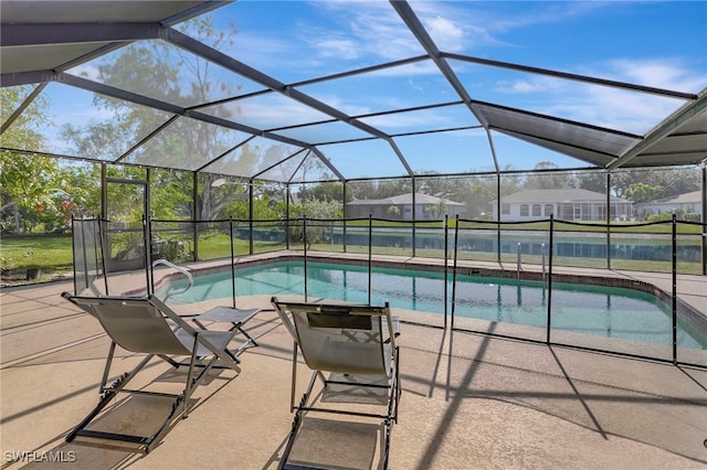 view of swimming pool with glass enclosure and a patio