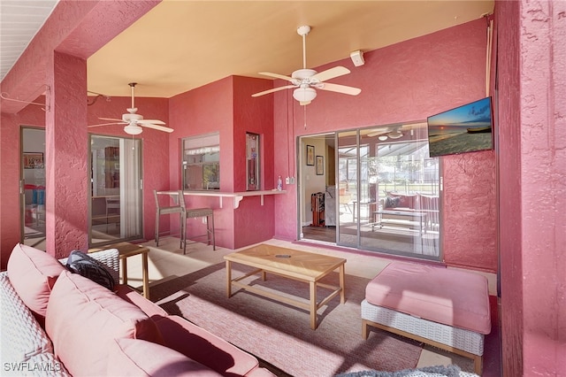 living room with beamed ceiling and ceiling fan