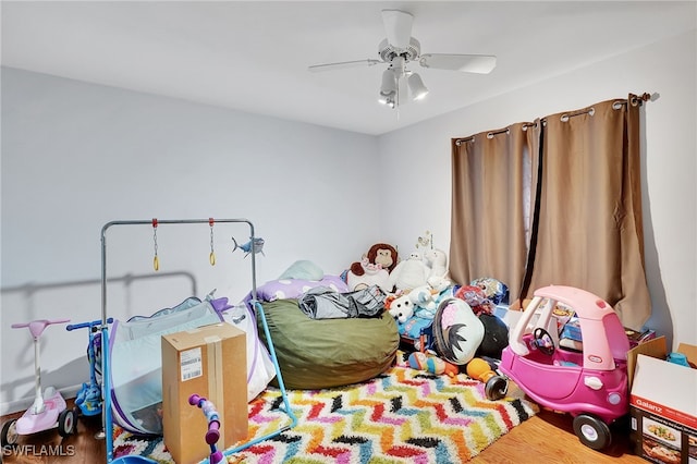 bedroom with ceiling fan and wood-type flooring