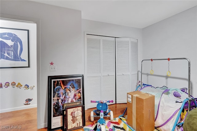 bedroom with a closet and light hardwood / wood-style flooring