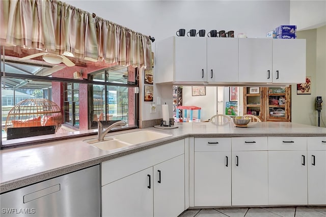 kitchen with white cabinets, a healthy amount of sunlight, stainless steel dishwasher, and sink