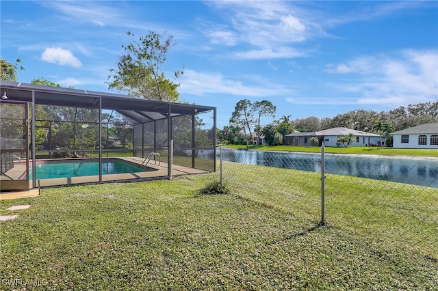 view of yard with a lanai and a water view