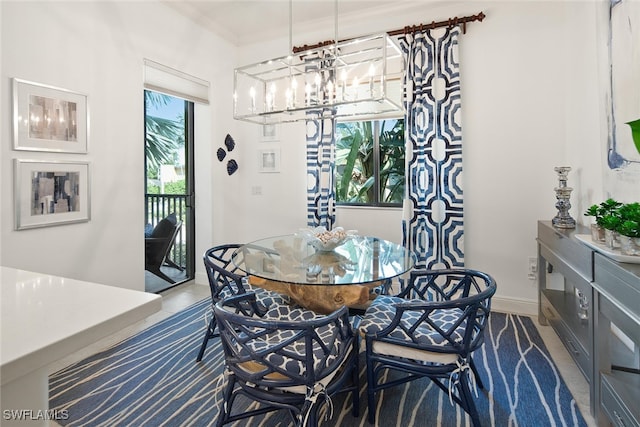 dining area featuring crown molding and a chandelier