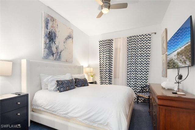 bedroom with ceiling fan and dark carpet