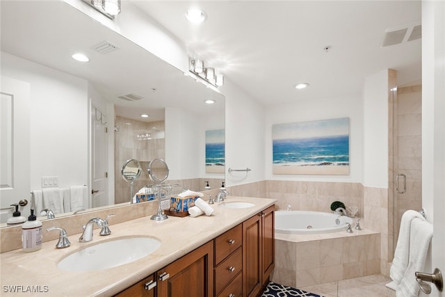 bathroom featuring independent shower and bath, tile patterned flooring, and vanity