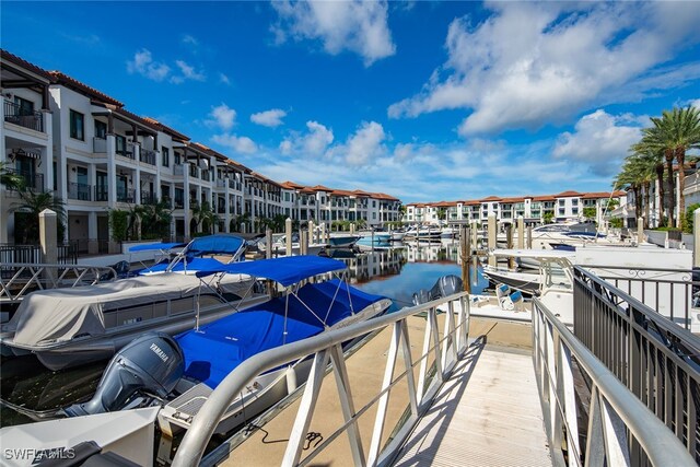 dock area featuring a water view and a balcony