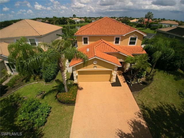 view of front facade with a front yard and a garage