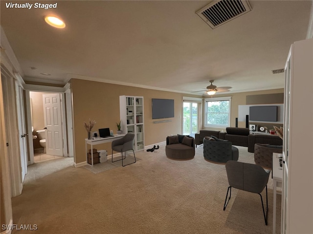 carpeted living room with crown molding and ceiling fan