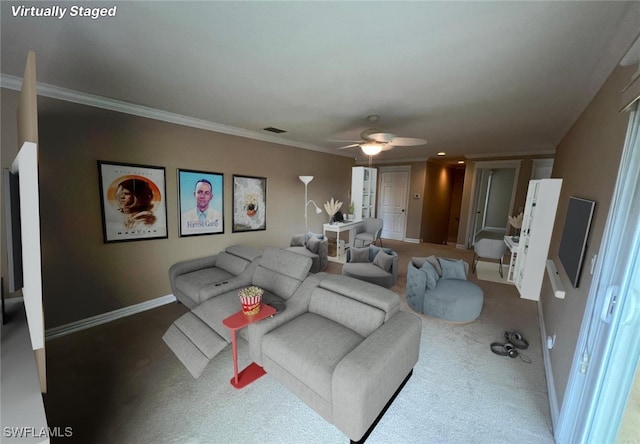 carpeted living room with ceiling fan and crown molding