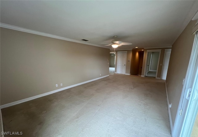 spare room featuring ornamental molding, carpet, and ceiling fan