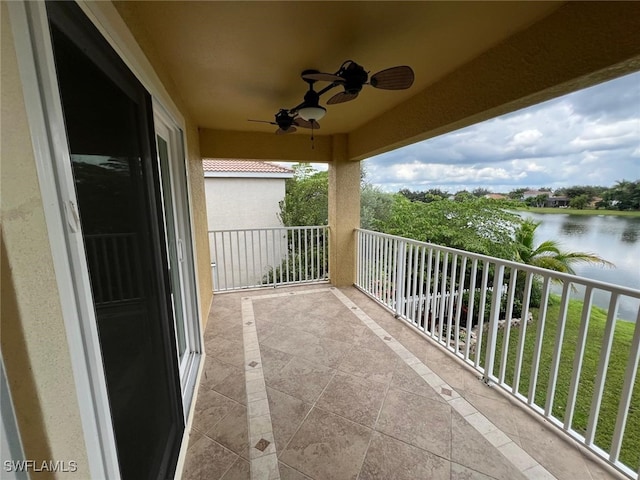 balcony featuring ceiling fan and a water view