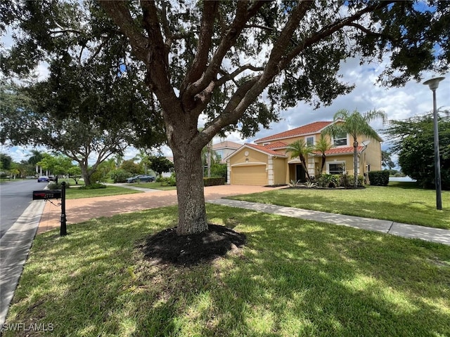 view of front of property with a garage and a front lawn