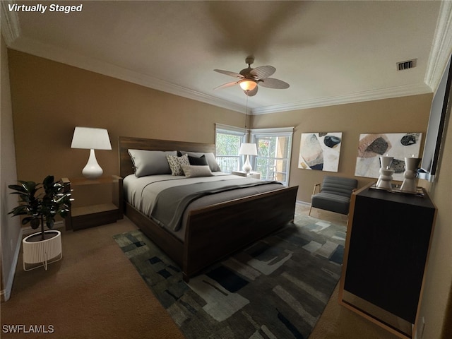 carpeted bedroom featuring ceiling fan and ornamental molding