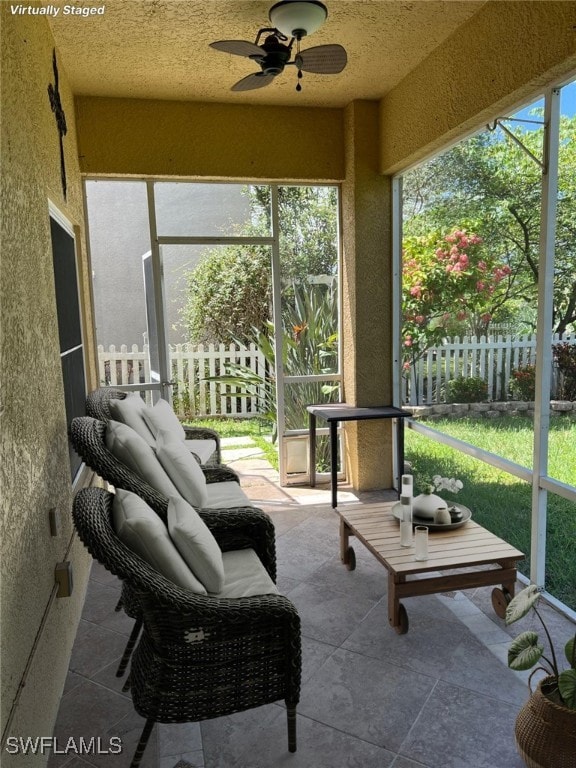 sunroom / solarium featuring ceiling fan