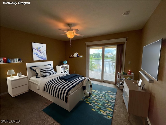 bedroom featuring dark colored carpet, ceiling fan, and access to exterior