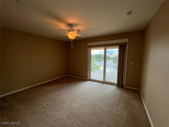 spare room featuring ceiling fan and carpet flooring