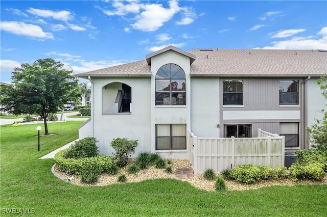 rear view of property with a lawn