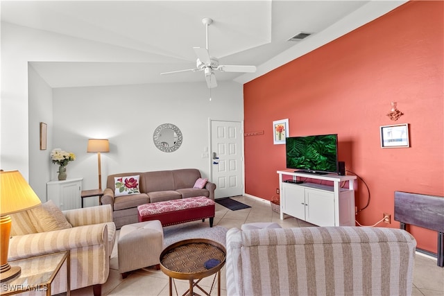 living room with ceiling fan, vaulted ceiling, and light tile patterned floors