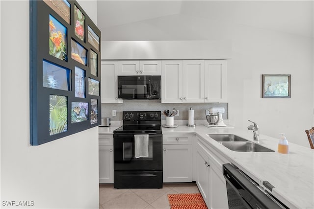 kitchen featuring decorative backsplash, white cabinets, black appliances, lofted ceiling, and sink