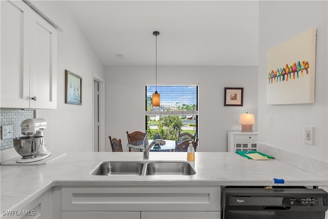 kitchen with tasteful backsplash, white cabinets, black dishwasher, pendant lighting, and sink