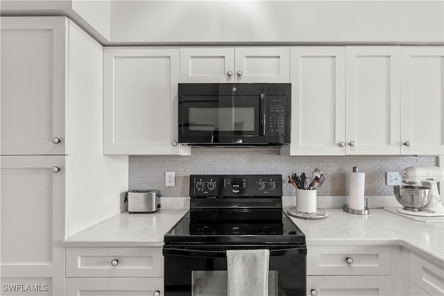 kitchen with light stone countertops, white cabinetry, tasteful backsplash, and black appliances