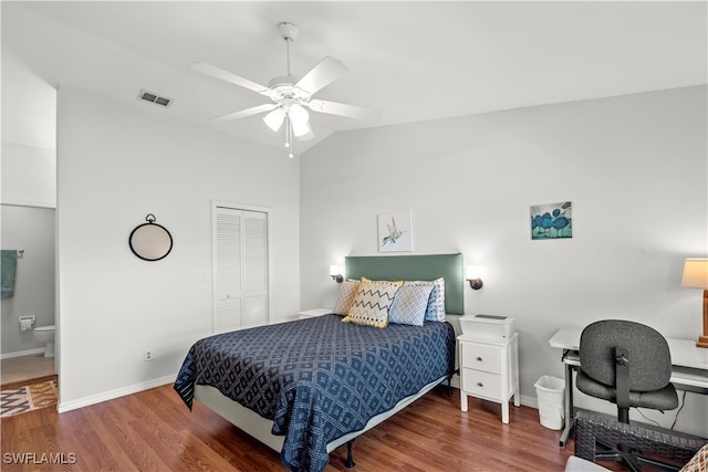 bedroom featuring vaulted ceiling, dark hardwood / wood-style flooring, a closet, ceiling fan, and ensuite bath