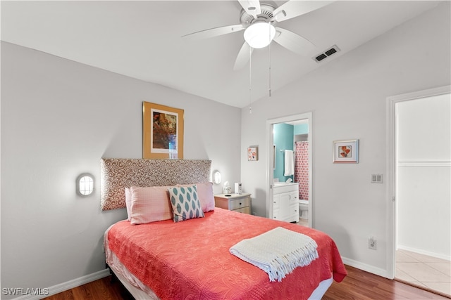 bedroom with wood-type flooring, lofted ceiling, ceiling fan, and ensuite bathroom