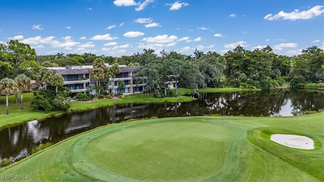 view of property's community with a yard and a water view