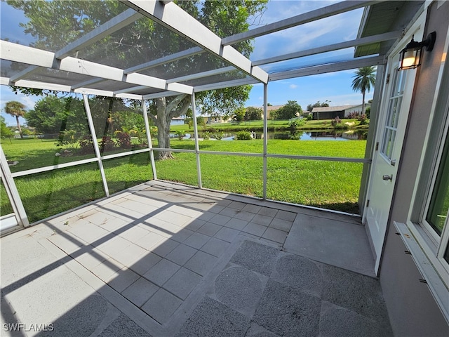 unfurnished sunroom with a water view