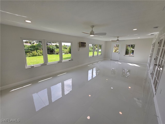 tiled empty room featuring ceiling fan, a wall unit AC, and french doors