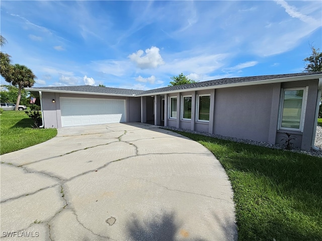 ranch-style house with a garage and a front lawn