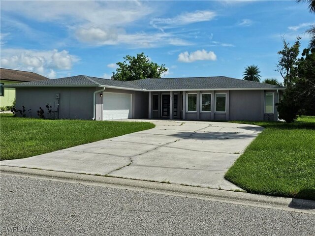 ranch-style house with a garage and a front lawn