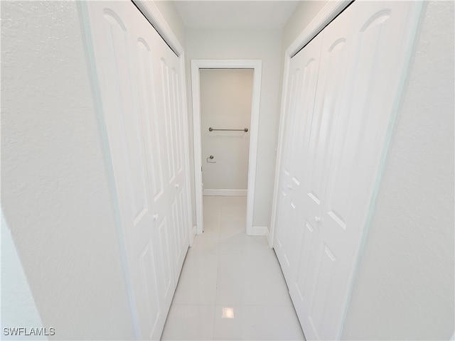 hallway featuring light tile patterned floors