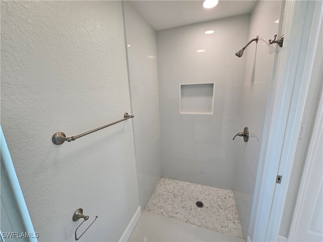 bathroom with a tile shower