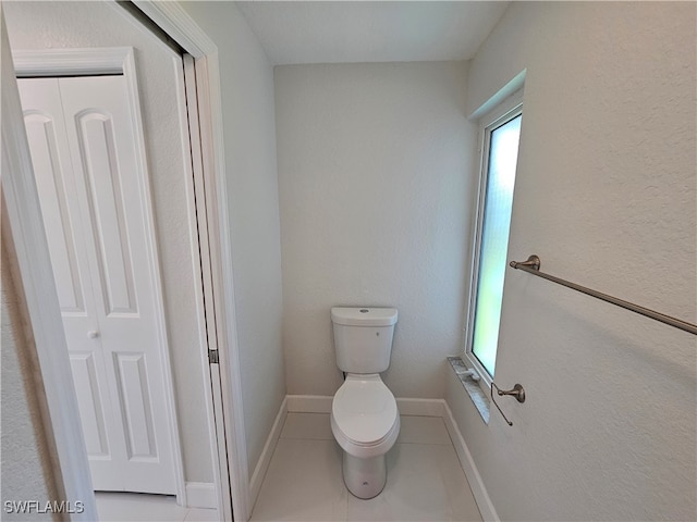 bathroom featuring tile patterned flooring and toilet