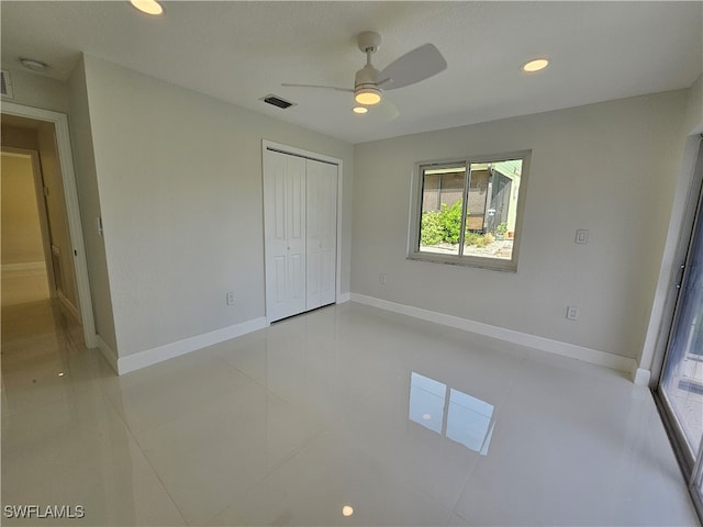 interior space featuring ceiling fan, light tile patterned flooring, and a closet