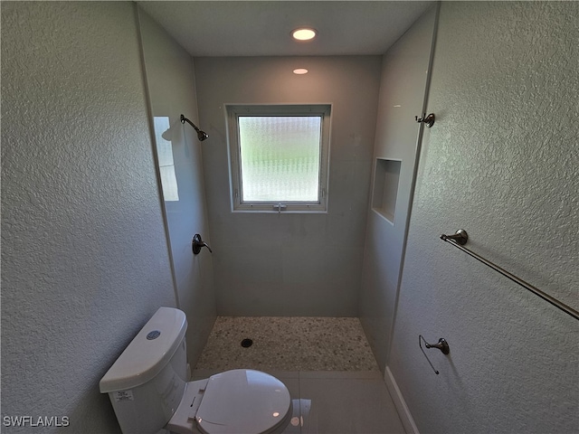 bathroom with toilet and a shower